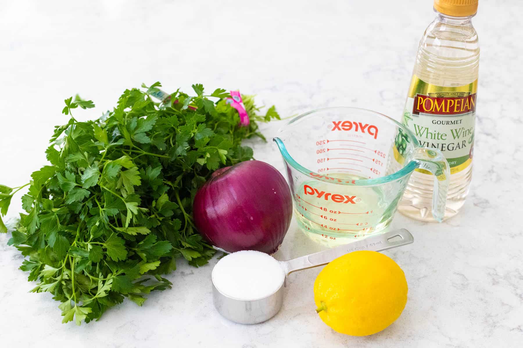 The fresh red onion and other ingredients are on the kitchen counter.