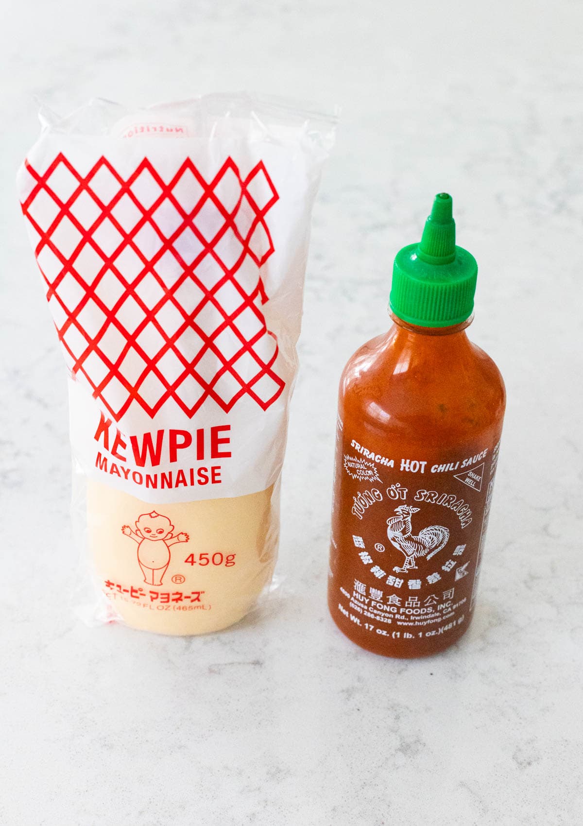 The ingredients to make Spicy Mayo are on the kitchen counter.