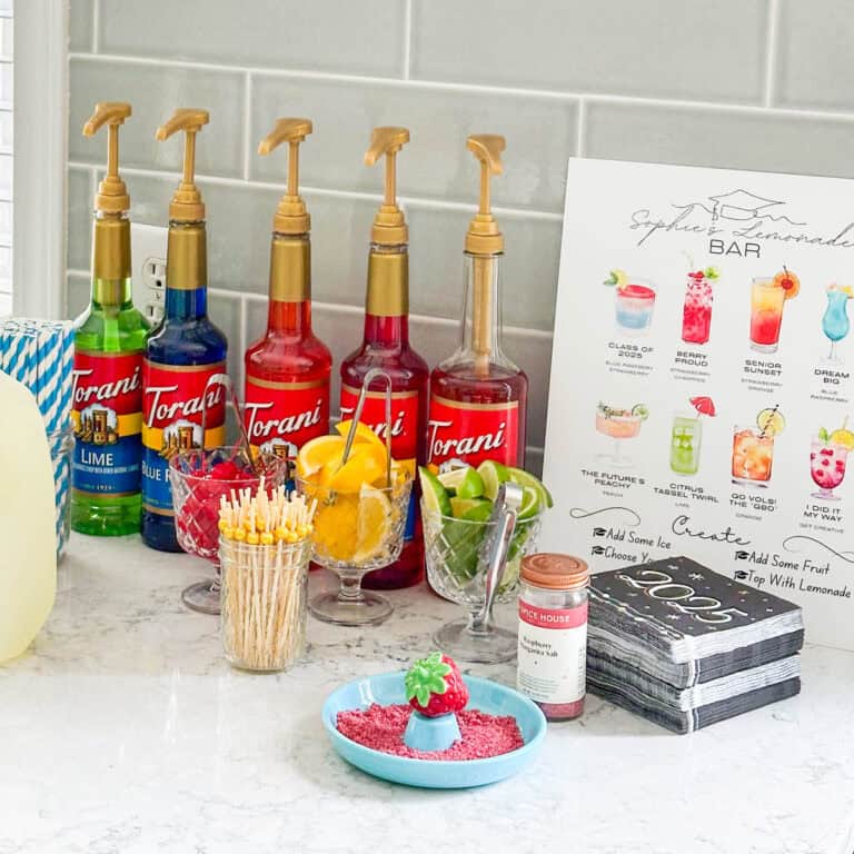 A DIY lemonade bar with flavored syrups and garnishes is set up in the kitchen.