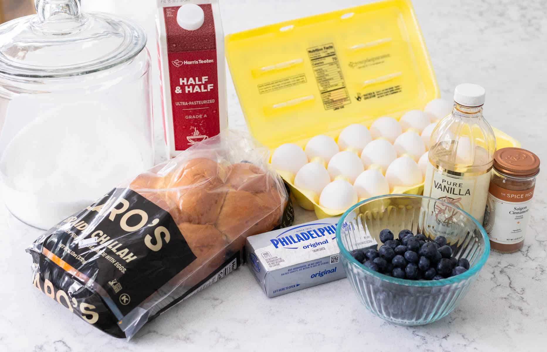 The loaf of bread and other ingredients to make the breakfast casserole are on the kitchen counter.