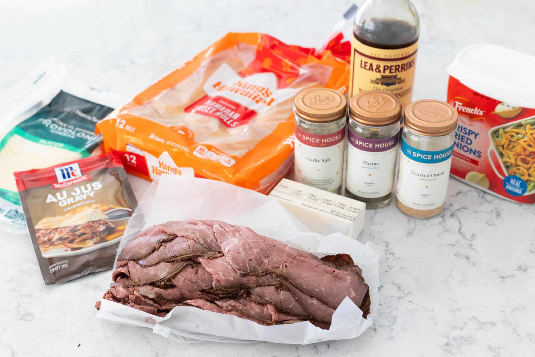 The ingredients to make homemade French Dip Sliders are lined up on the kitchen counter. 