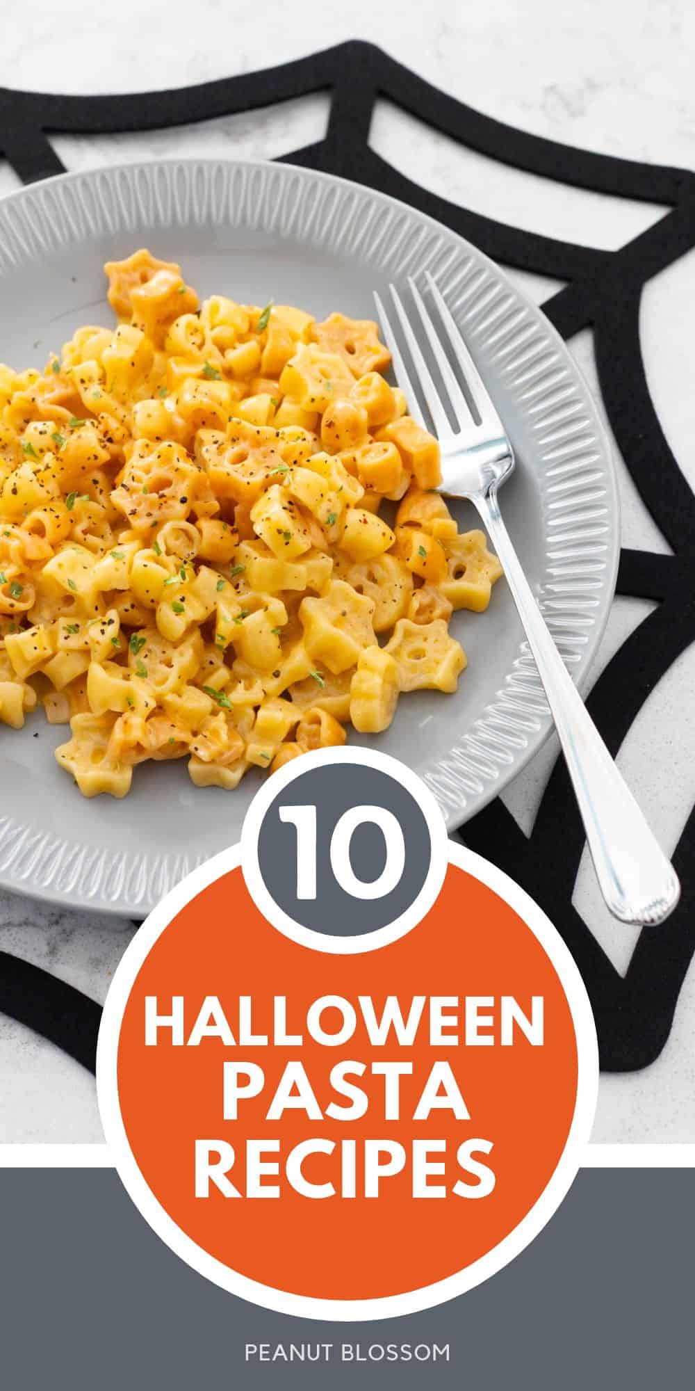 A gray plate is filled with orange Halloween mac and cheese and rests on a spider web placemat.