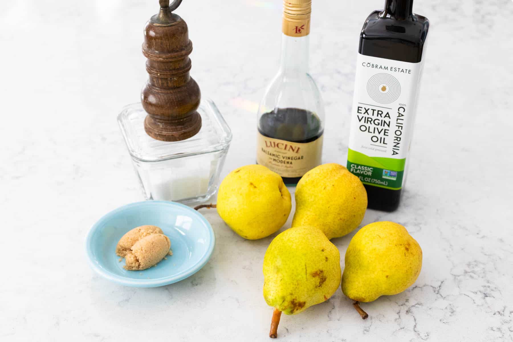 The ingredients to make roasted pears are on the kitchen counter.