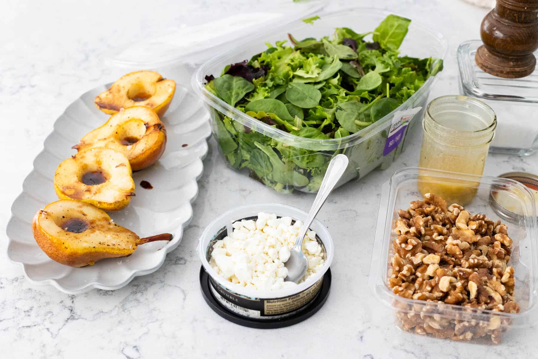 The ingredients to make an easy roasted pear salad are on the kitchen counter.
